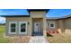 Charming home featuring a well-manicured lawn, neutral stucco exterior, and a welcoming front entrance at 6741 Heavitree Dr, Sebring, FL 33876
