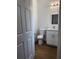 Bright half bathroom featuring vinyl floors, a toilet and modern vanity with storage at 6741 Heavitree Dr, Sebring, FL 33876