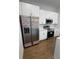 Modern kitchen features stainless steel appliances, white cabinetry, and a sleek design at 6741 Heavitree Dr, Sebring, FL 33876