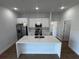 Kitchen with a large island, modern appliances, quartz counters, and pendant lighting at 6741 Heavitree Dr, Sebring, FL 33876