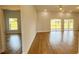 Open-concept living room with hardwood floors and sliding glass doors leading to a large yard at 6741 Heavitree Dr, Sebring, FL 33876