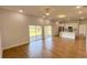 Open floor plan with wood floors, large windows, sliding glass doors, and a modern kitchen with stainless appliances at 6741 Heavitree Dr, Sebring, FL 33876