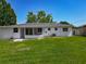 Lawn extending from the rear of the house with a screened in patio on the back of the house at 8228 Shriver Dr, Orlando, FL 32822