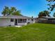 Spacious fenced backyard with lush green grass and mature trees at 8228 Shriver Dr, Orlando, FL 32822