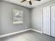 This bedroom features a ceiling fan, closet, and a window that brings natural light at 8228 Shriver Dr, Orlando, FL 32822
