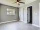 Bright bedroom with neutral paint, light wood-look floors, and ceiling fan at 8228 Shriver Dr, Orlando, FL 32822