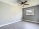 This bedroom features a ceiling fan and window that provides natural light at 8228 Shriver Dr, Orlando, FL 32822