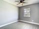 Cozy bedroom with light grey walls, white trim, light wood-look floors and a window at 8228 Shriver Dr, Orlando, FL 32822