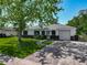 Charming single-story home featuring a well-manicured lawn, brick accents, attached garage and mature tree at 8228 Shriver Dr, Orlando, FL 32822