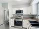 Close up of updated kitchen featuring stainless steel appliances and granite countertops at 8228 Shriver Dr, Orlando, FL 32822