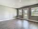 Bright living room with grey walls, white trim, recessed lighting, light wood-look floors, and an exterior door at 8228 Shriver Dr, Orlando, FL 32822