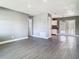 Bright living room with grey walls, white trim, light wood-look floors and view into the kitchen at 8228 Shriver Dr, Orlando, FL 32822
