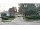 Charming single-story home featuring a two-car garage, brick driveway, and lush landscaping at 8532 Bay Springs Dr, Orlando, FL 32819