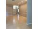 Spacious living room with tile floors and a soaring ceiling with transom window at 8532 Bay Springs Dr, Orlando, FL 32819