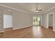 Spacious bedroom showcasing durable wooden floors, a ceiling fan, and access to a private outdoor balcony at 860 N Orange Ave # 306, Orlando, FL 32801
