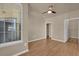 Bedroom with laminate wood floors, ceiling fan and an organized closet space at 860 N Orange Ave # 306, Orlando, FL 32801