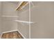 Walk-in closet with built-in shelving, hanging rods and wood laminate flooring at 860 N Orange Ave # 306, Orlando, FL 32801
