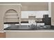Kitchen featuring black appliances, white cabinets, wooden floors, and a black countertop at 860 N Orange Ave # 306, Orlando, FL 32801