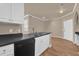 The kitchen has modern appliances including a dishwasher, black countertops, and durable wooden floors at 860 N Orange Ave # 306, Orlando, FL 32801