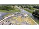 Beautiful aerial view showcasing a pristine golf course, clubhouse, parking, and water views at 8600 Castile Rd, Sebring, FL 33876