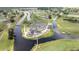 Aerial view of the updated clubhouse surrounded by waterways and lush green fairways in a golf community at 8600 Castile Rd, Sebring, FL 33876