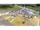 Aerial view showing the clubhouse with manicured lawns, golf course, and water views at 8600 Castile Rd, Sebring, FL 33876