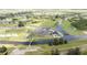 Panoramic aerial view of a beautiful golf course community with winding waterways and lush green fairways at 8600 Castile Rd, Sebring, FL 33876