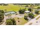 Aerial view showcasing community courts with seating and a nearby parking area and community center at 8600 Castile Rd, Sebring, FL 33876