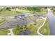 Beautiful aerial view showcasing clubhouse with water views, parking, and well-maintained landscaping at 8600 Castile Rd, Sebring, FL 33876