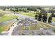 Scenic aerial view of the community clubhouse with water views and meticulously maintained landscaping at 8600 Castile Rd, Sebring, FL 33876