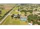 This aerial view shows the community with manicured lawns, nearby tennis courts, and clear roads at 8600 Castile Rd, Sebring, FL 33876