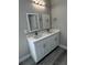 Bathroom showcasing a double vanity with modern fixtures and lighting at 8600 Castile Rd, Sebring, FL 33876