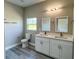 Bathroom featuring double sinks, white cabinetry, and modern fixtures at 8600 Castile Rd, Sebring, FL 33876