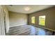 Large bedroom with a hardwood floor and two bright windows at 8600 Castile Rd, Sebring, FL 33876