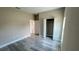 Neutral bedroom with wood-look floors and an open closet at 8600 Castile Rd, Sebring, FL 33876