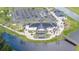 An aerial photo showcases the updated clubhouse with outdoor seating near the parking area and golf cart spaces at 8600 Castile Rd, Sebring, FL 33876