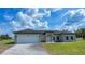 Charming single-story home featuring a paver driveway and a two-car garage at 8600 Castile Rd, Sebring, FL 33876