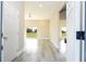 View of the home's foyer and living space, with wood-look floors and an open floor plan at 8600 Castile Rd, Sebring, FL 33876