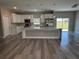 Open concept kitchen with stainless steel appliances, pendant lighting, and a breakfast bar at 8600 Castile Rd, Sebring, FL 33876