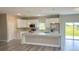 Modern kitchen featuring white cabinetry, stainless steel appliances, and a large island at 8600 Castile Rd, Sebring, FL 33876