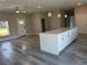 Kitchen island features a quartz countertop with white cabinets, pendant lights, and wood flooring at 8600 Castile Rd, Sebring, FL 33876