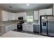 Modern kitchen featuring stainless steel appliances and white cabinets at 8600 Castile Rd, Sebring, FL 33876