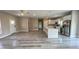 Spacious open-concept living room and kitchen with stainless steel appliances and wood-look floors at 8600 Castile Rd, Sebring, FL 33876
