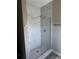 Modern bathroom showcasing a glass-enclosed shower with stylish marble-patterned walls and complementary tile flooring at 8600 Castile Rd, Sebring, FL 33876