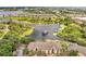 Aerial view of neighborhood and complex with scenic lake and surrounding greenery at 8801 Latrec Ave # 8101, Orlando, FL 32819