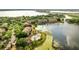 Stunning aerial view of the community featuring lush greenery, a shimmering lake, and a sparkling swimming pool at 8801 Latrec Ave # 8101, Orlando, FL 32819