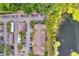 Aerial view of building, parking lot, and nearby pond with water lilies at 8801 Latrec Ave # 8101, Orlando, FL 32819