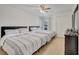 Bedroom featuring hardwood floors, two beds, and a ceiling fan at 8801 Latrec Ave # 8101, Orlando, FL 32819