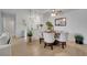 Bright and open dining area with a round table, comfortable chairs, and a view into the modern kitchen at 8801 Latrec Ave # 8101, Orlando, FL 32819