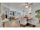 Stylish dining area with a modern ceiling fan, and views of the living room and kitchen at 8801 Latrec Ave # 8101, Orlando, FL 32819